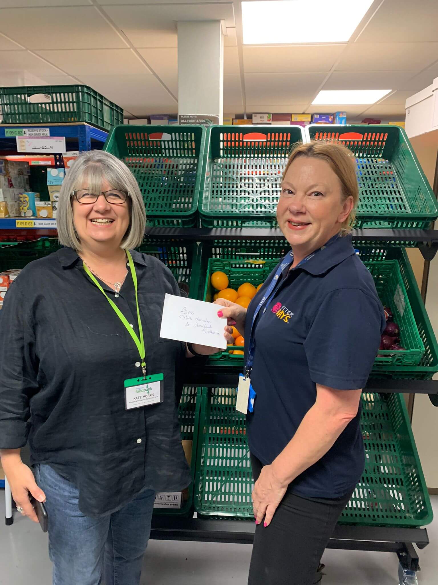 Two ladies standing in a supermarket smiling