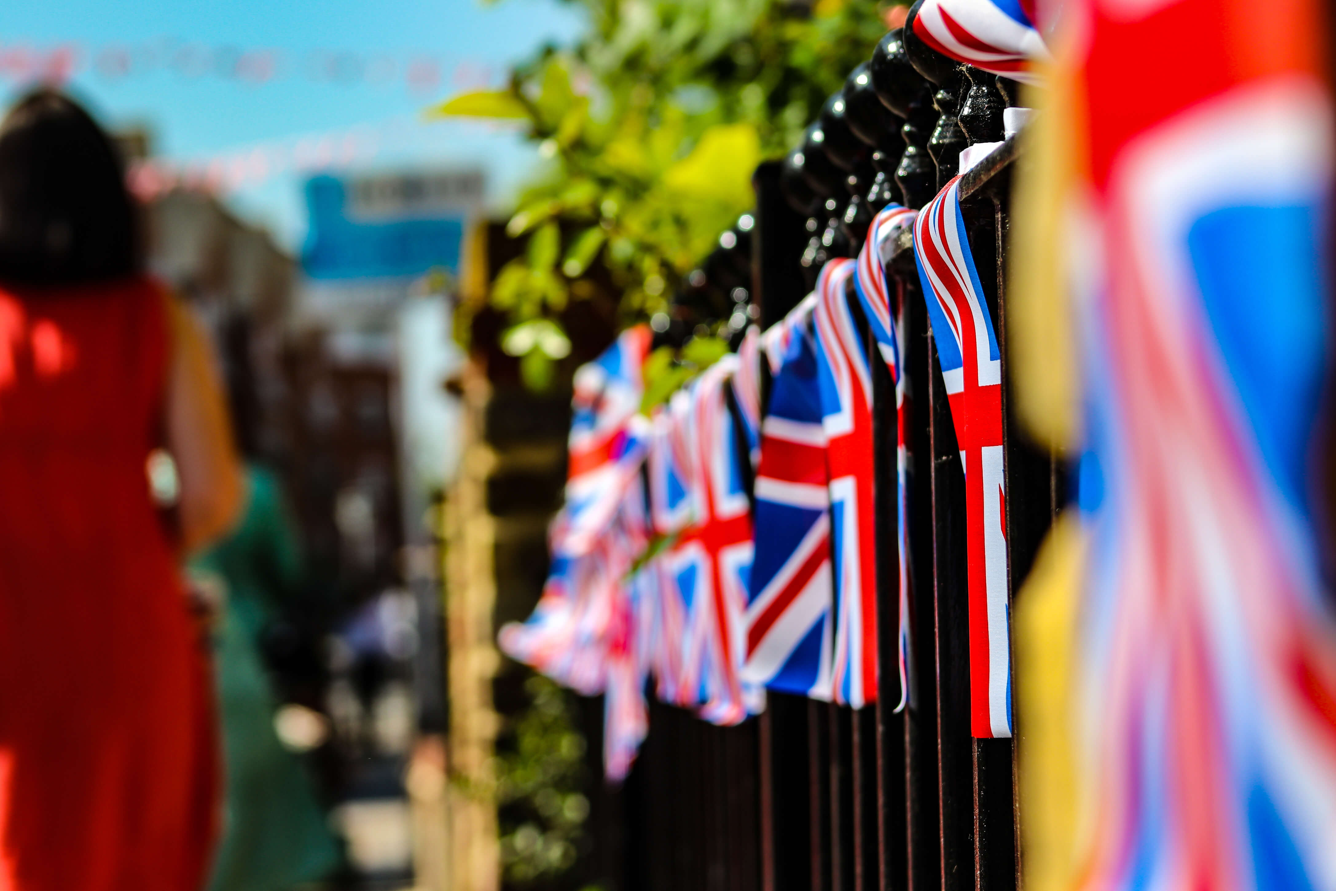 Union Jack flags hanging on a fence for the kings coronation