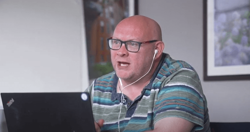 man sitting in front of a laptop