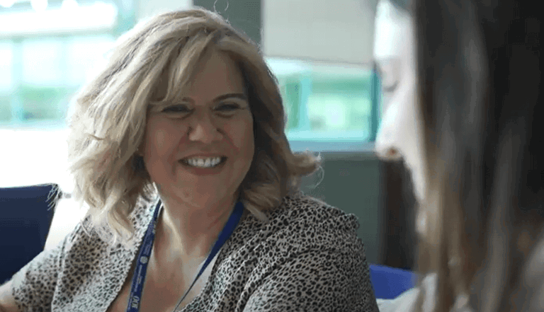 lady sitting on a chair talking to a friend laughing lady sitting on a chair talking to a friend laughing