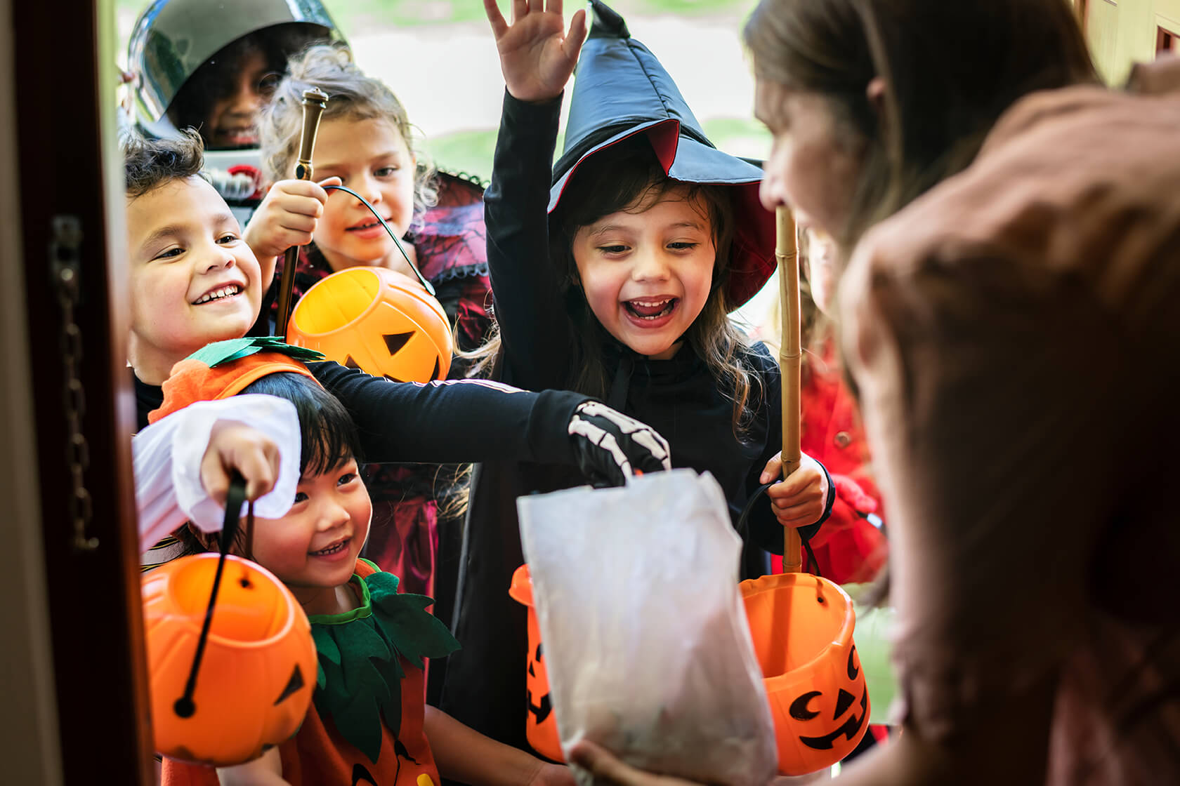 group of children trick or treating collecting sweets