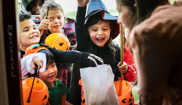group of children trick or treating collecting sweets group of children trick or treating collecting sweets