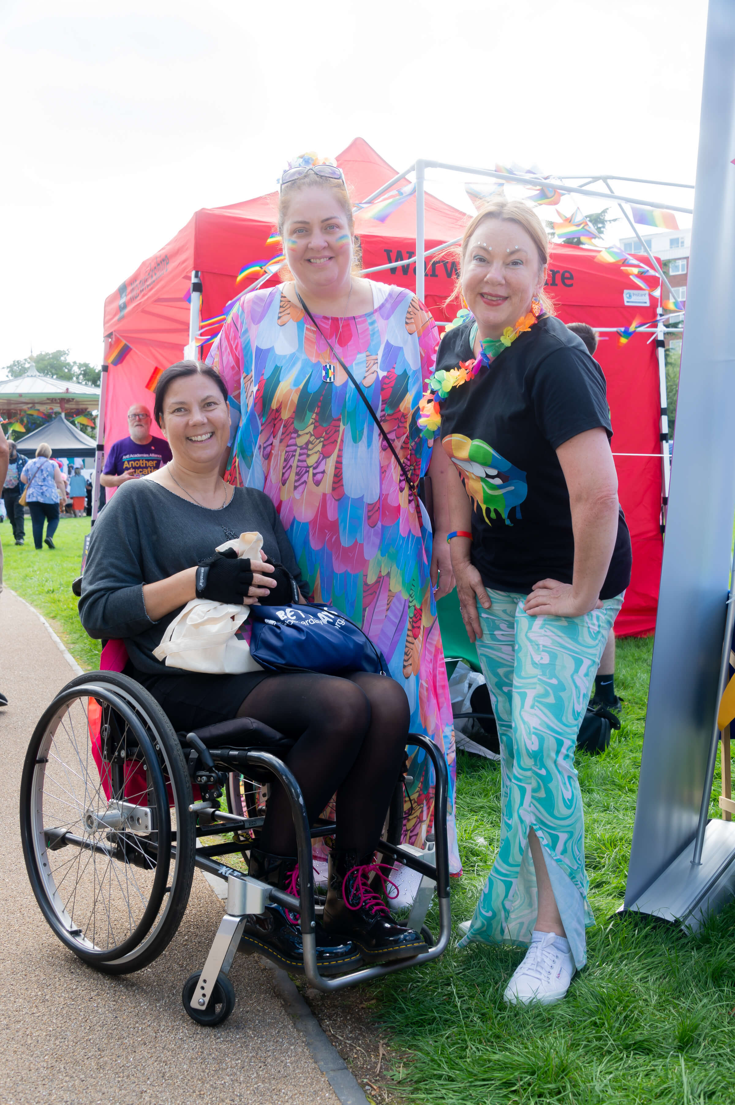 undefined three people participating in pride month smiling