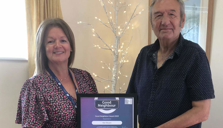 Man and lady standing holding a certificate Man and lady standing holding a certificate